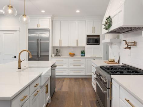 kitchen with white counters and brass fixtures